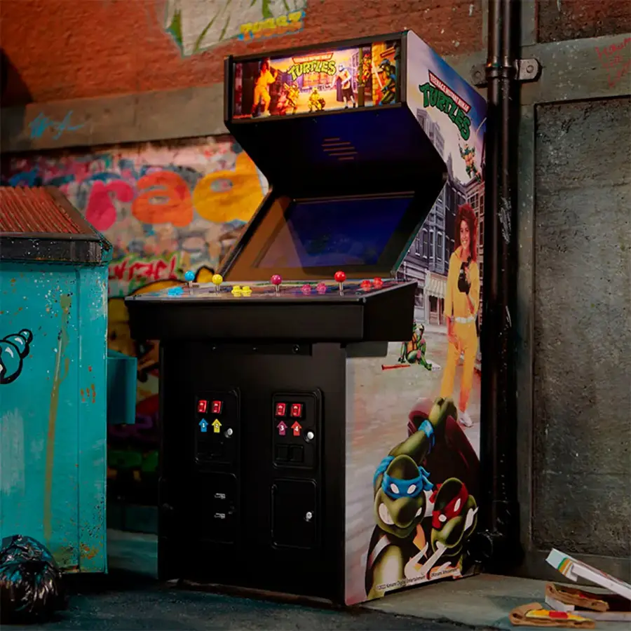 The image features a Teenage Mutant Ninja Turtles arcade machine, which is a popular video game from the 1990s. The machine is placed next to a wall, and the game is set up for two players. The machine is designed to look like a refrigerator, adding a unique touch to the gaming experience. The game is likely to be a fun and nostalgic experience for those who played it back in the day.
