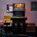 The image features a black arcade machine with a Turtles game on display. The machine is located next to a yellow machine and a brick wall. The arcade machine is set up for a high score tournament, which is coming soon. The machine is also equipped with a Polybius change available.