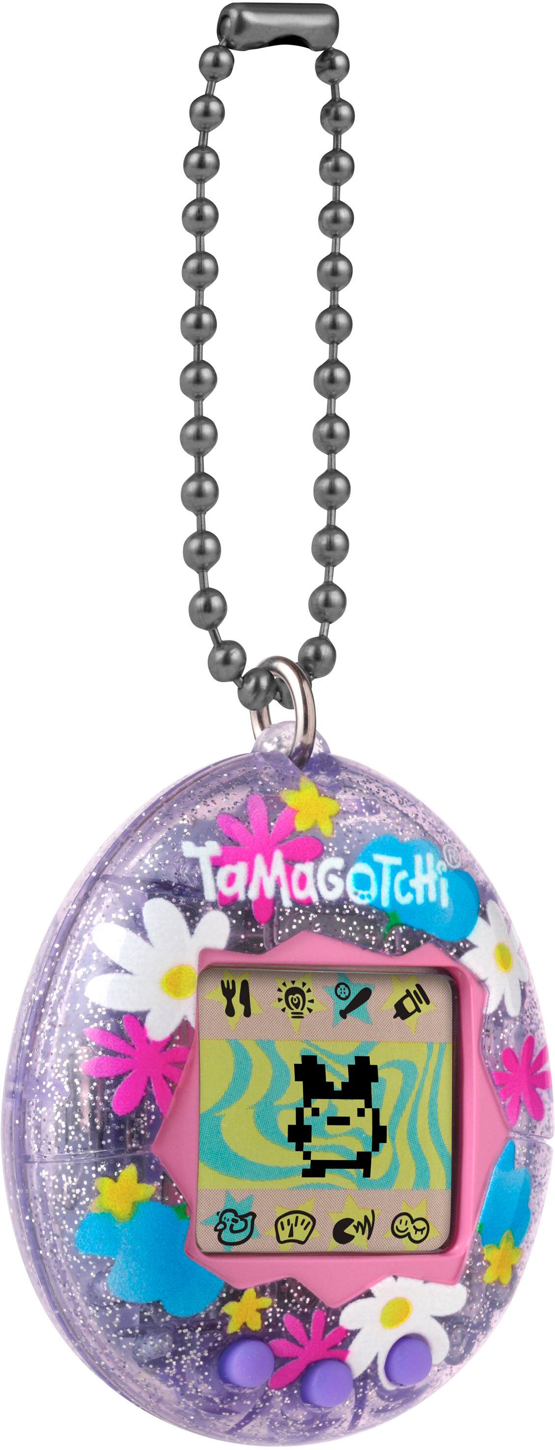 The image features a Tamagochi egg-shaped toy with a chain around its neck. The toy has a cat face on it, and it is designed to resemble a small egg. The Tamagochi is a popular children's toy that has been around since the 1990s. It is a digital pet that requires care and attention, such as feeding and playing with it, to keep it happy and healthy. The toy is a fun and interactive way for kids to learn about responsibility and nurturing.