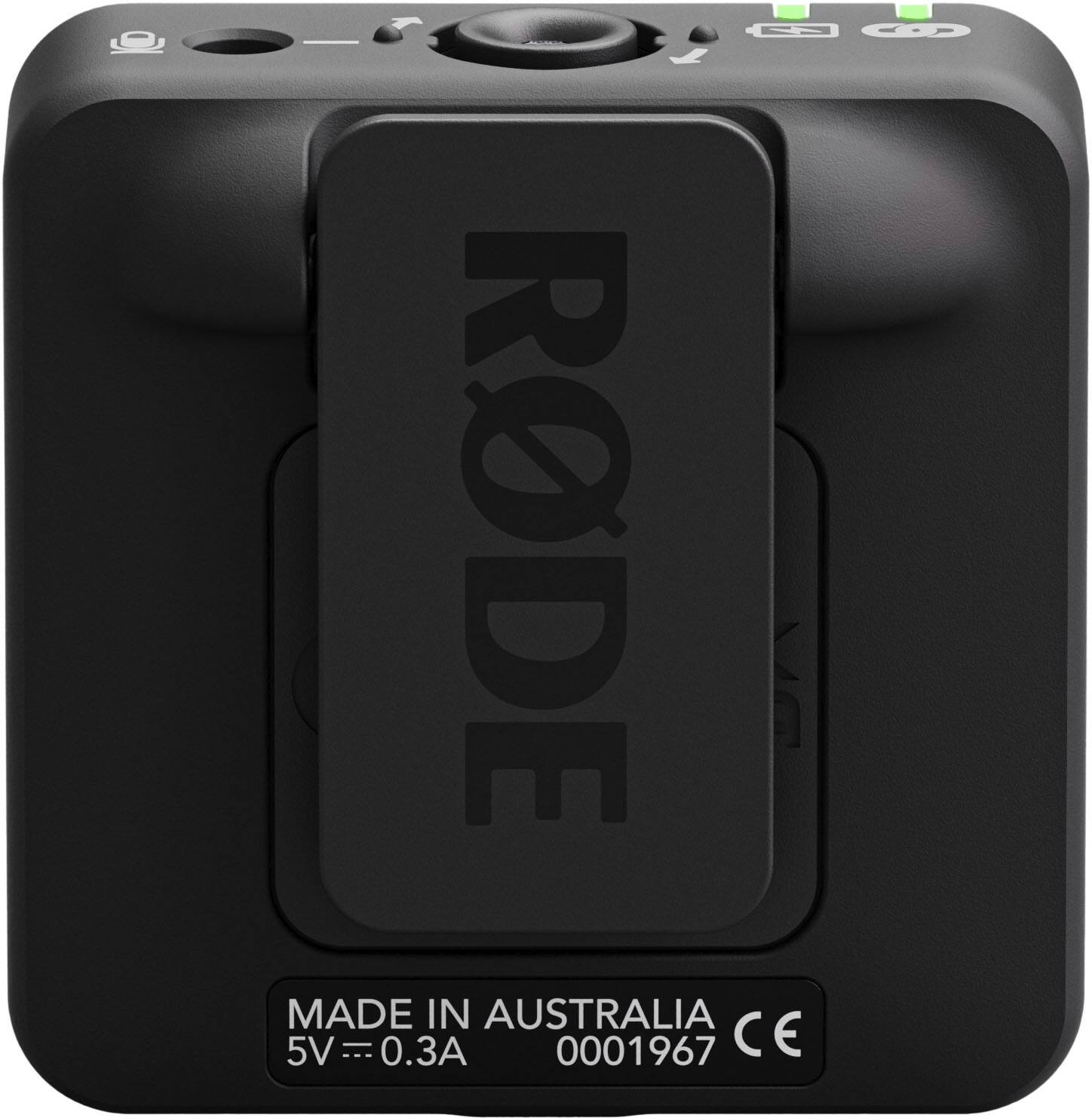 The image features a small black box with the word "RODE" written on it. The box is made in Australia and has a 5V USB port. The box is likely used for charging or powering electronic devices.