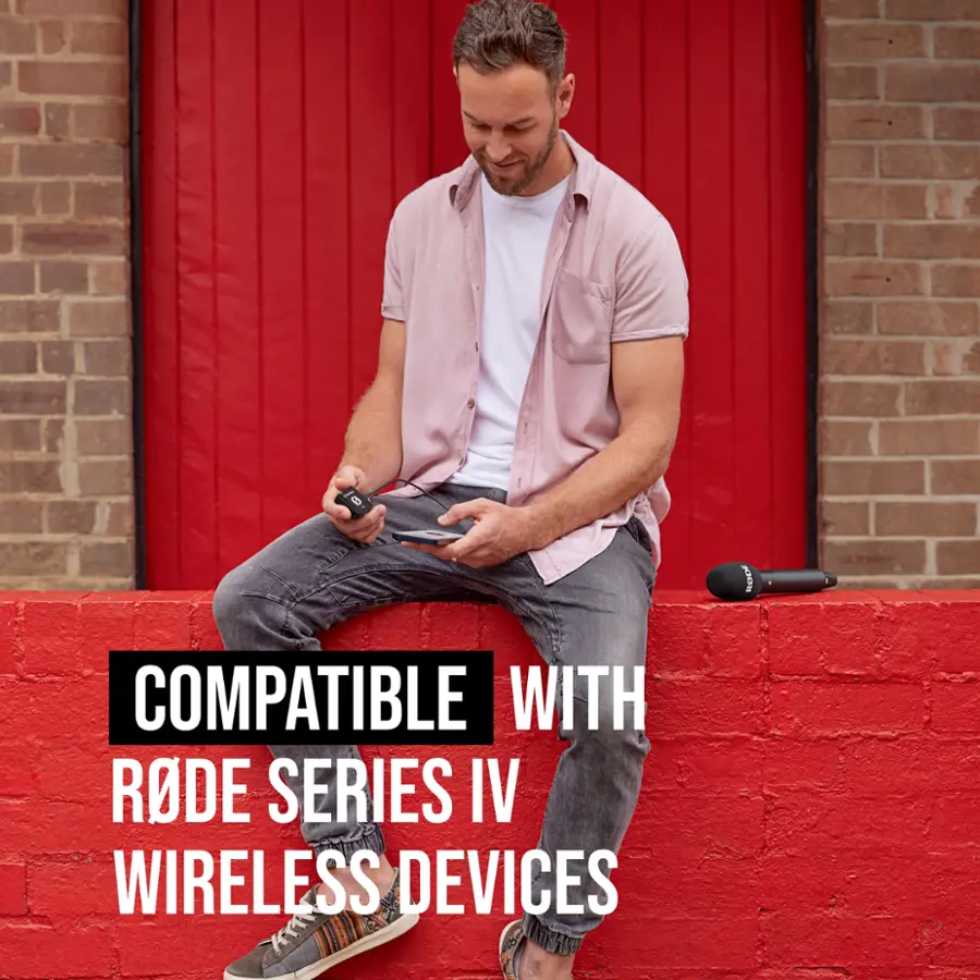 The man in the image is sitting on a red brick wall and holding a cell phone. The image is advertising a compatible device with Rode Series IV wireless devices.
