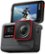 The image features a black Insta360 camera with a red and black design. The camera is turned on and displaying a picture of a man surfing on a wave. The camera is mounted on a stand, and it is positioned at an angle, showcasing the image on its screen. The Insta360 logo is visible on the camera, indicating its brand and model.