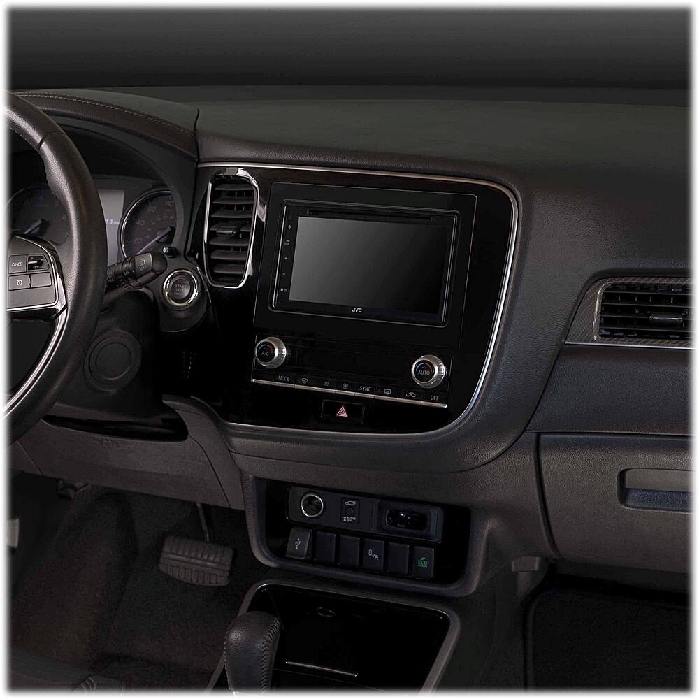 The car has a dashboard with a large screen in the center, which is currently displaying a blank screen. The dashboard also features a steering wheel and a control panel with buttons. The car is equipped with an entertainment system, which includes a television screen and a remote control. The car's interior is dark, giving it a sophisticated and modern appearance.