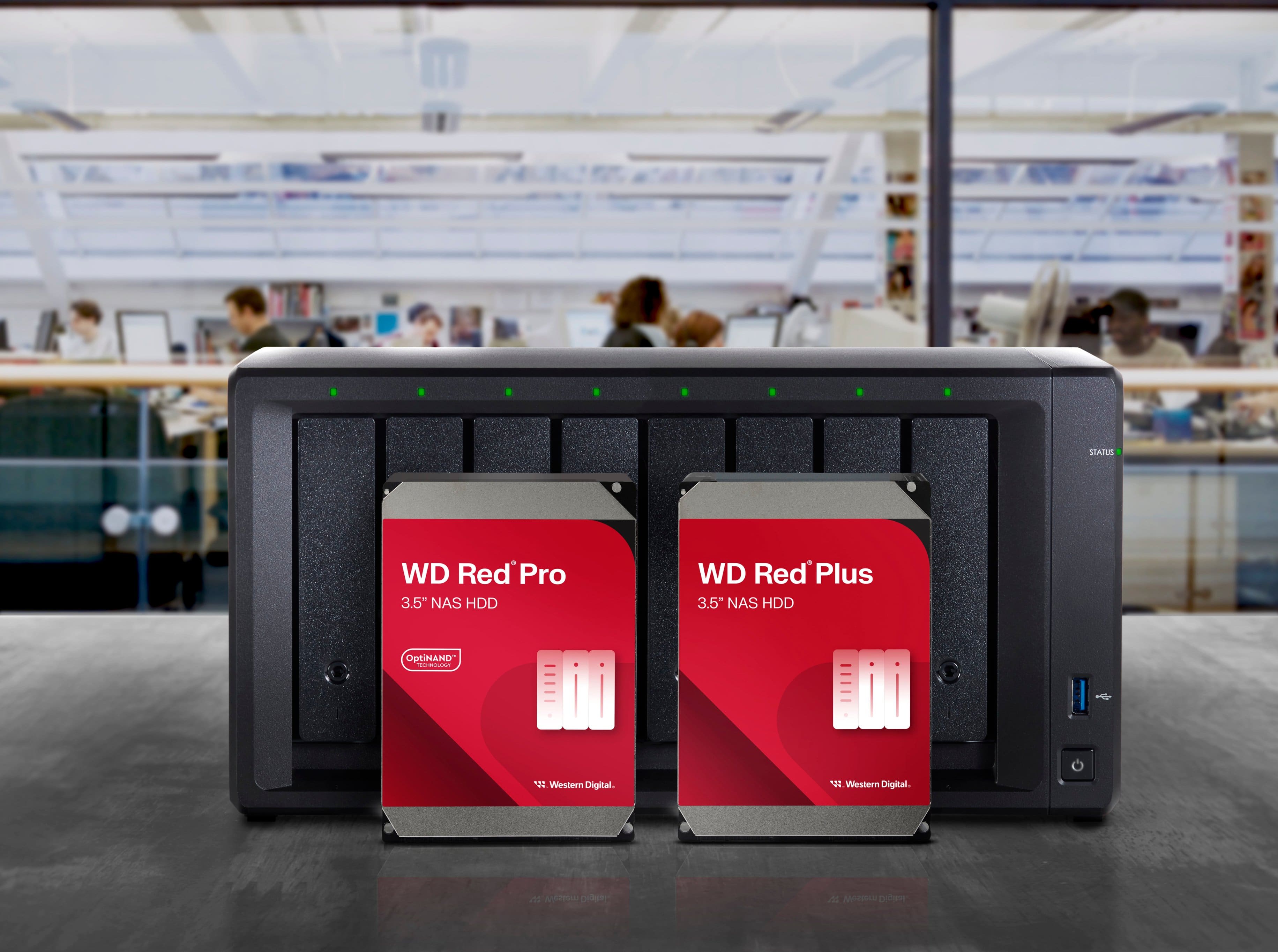 The image features a table with a WD Red Pro 3.5" NAS HDD and a WD Red Plus 3.5" NAS HDD. The table is surrounded by people, and there are also two books placed on the table. The scene suggests that the people might be working or studying in a library or a similar environment.