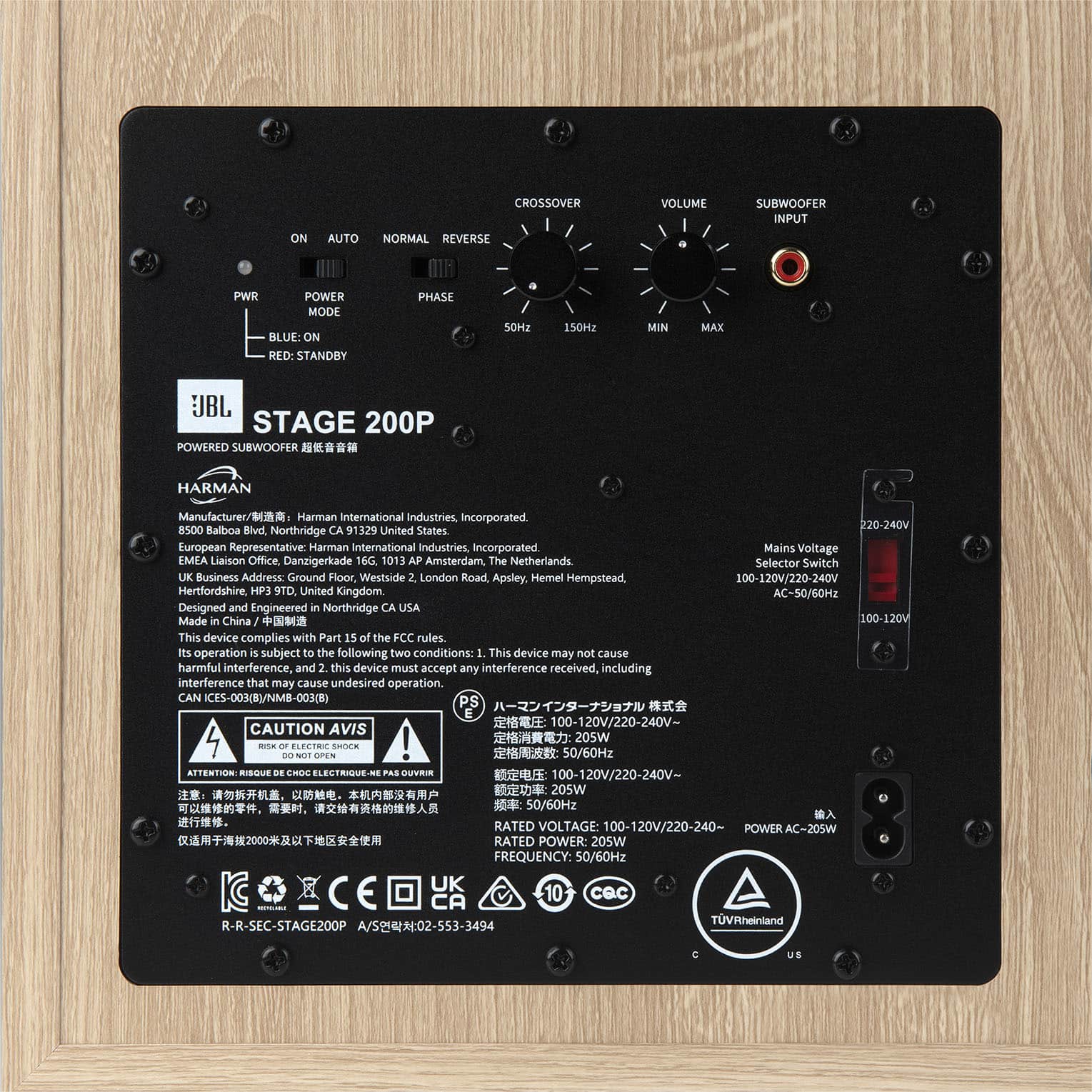 The image features a black electronic device with a label on the back. The label contains information about the device, including its manufacturer, Harman International Industries, and its power source, which is 100-120V. The device is designed and engineered in Northridge, California, and made in China. The label also includes a warning about compliance with FCC rules and the potential for harmful interference. Additionally, there is a caution sticker on the device, which may provide further information about its operation or safety features.