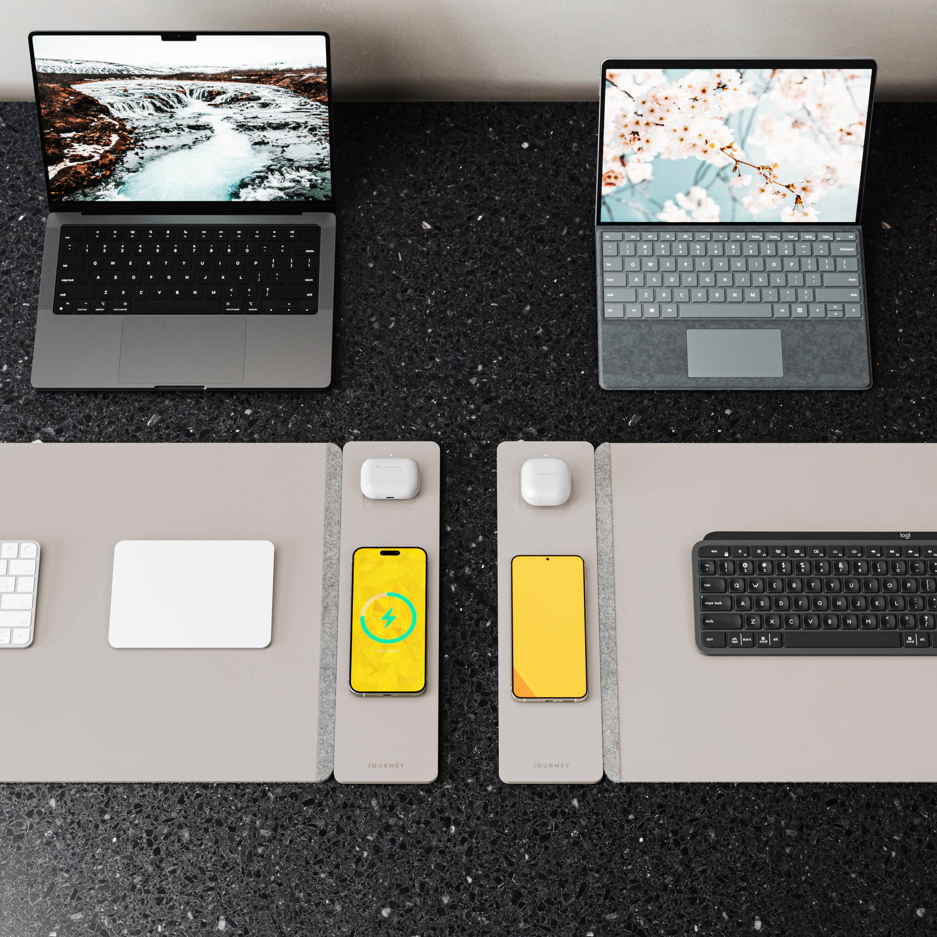 The image features two laptops placed side by side on a table. The laptops are accompanied by two keyboards, one of which is a wireless keyboard. Additionally, there are two computer mice placed near the laptops. The arrangement of the laptops, keyboards, and mice suggests that the setup is designed for a dual-screen workstation or a shared workspace.