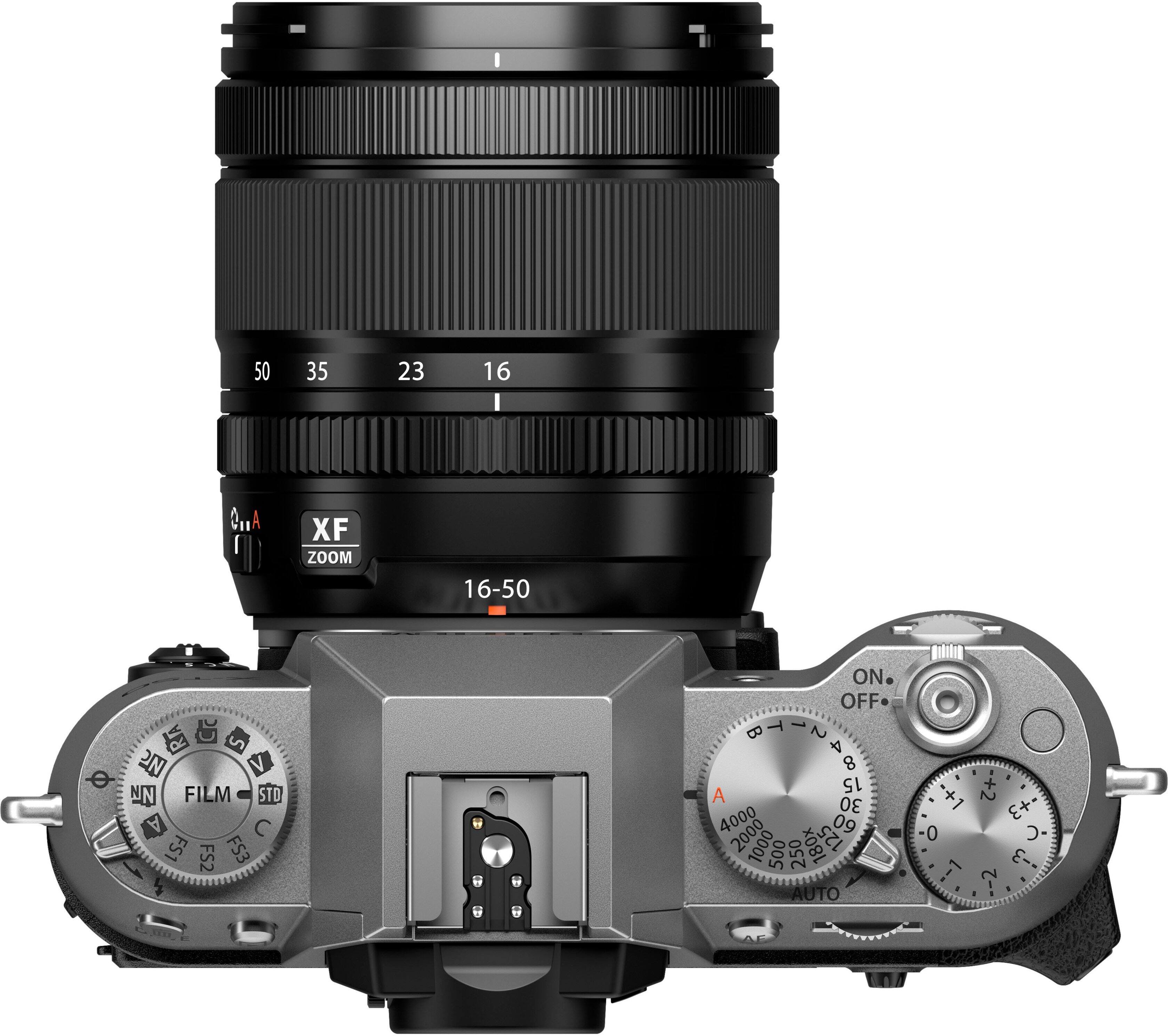 The image features a close-up of a camera lens, specifically a zoom lens, with a focus on the zoom ring. The lens is mounted on a camera, which has a zoom ring and a focus ring. The zoom ring is located on the left side of the lens, while the focus ring is on the right side. The camera also has a film standard setting, which is located at the bottom of the image.
