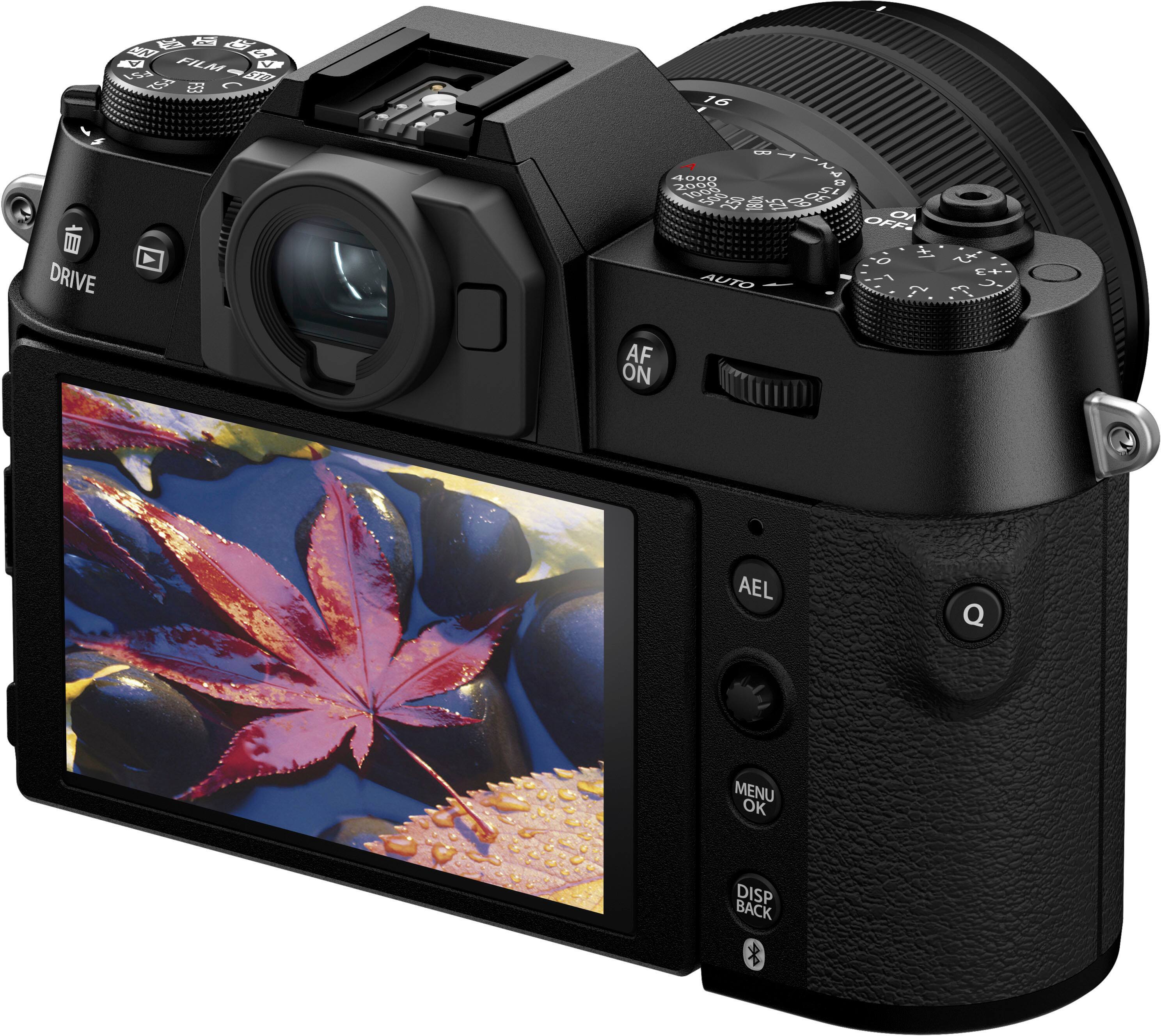 The image features a black digital camera with a large screen on the front. The camera has a viewfinder and a display screen, which is likely used for taking pictures and reviewing images. The camera is equipped with a zoom lens, which allows for adjusting the focal length to capture different perspectives. The camera also has a flash, which can be used to illuminate the subject in low-light conditions. Additionally, there are two dials on the camera, which may be used for adjusting settings or controlling the camera's functions.