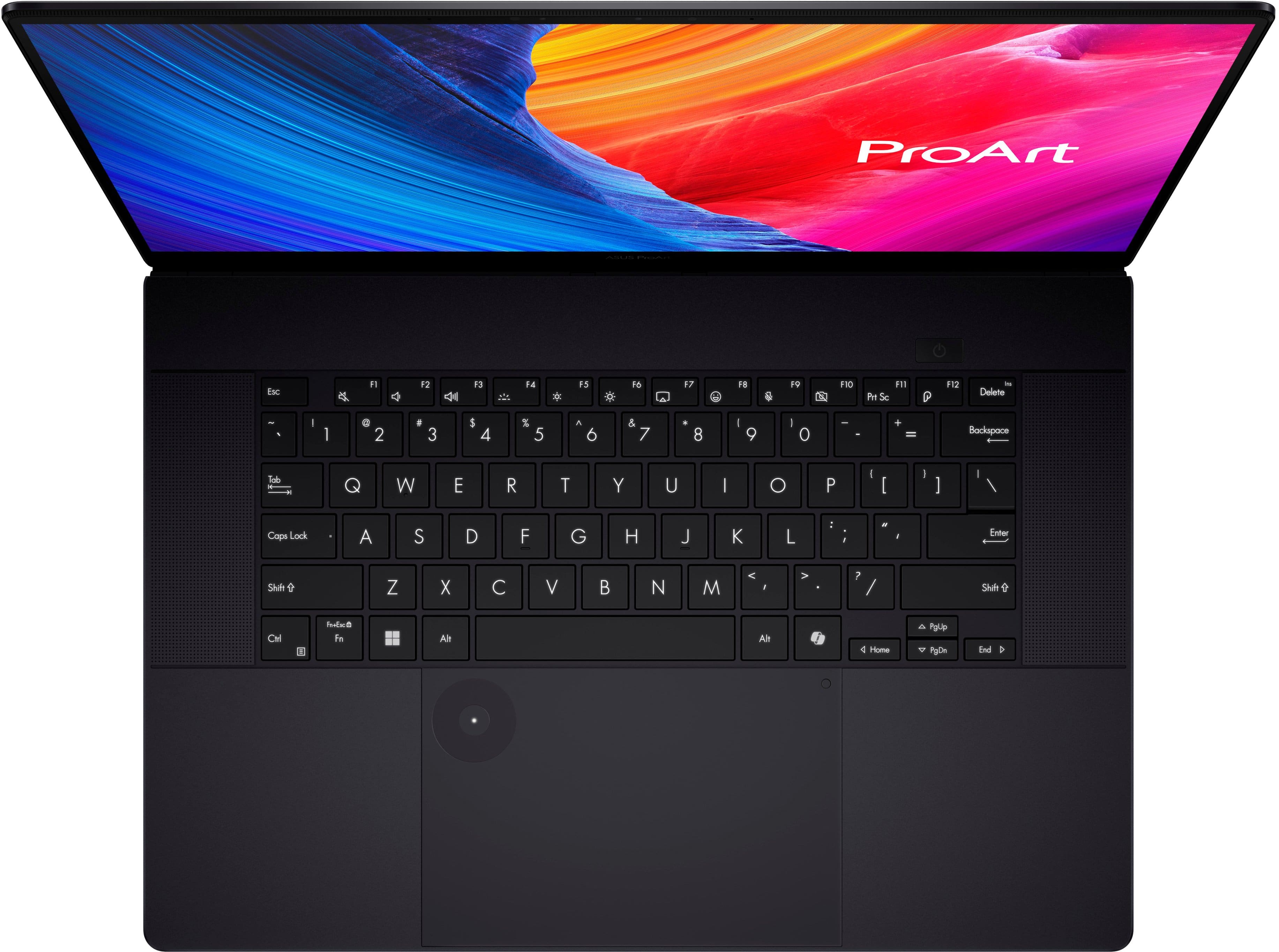 The image features a black laptop computer with a keyboard and a screen. The screen displays the ProArt logo, which is a brand of laptops. The keyboard is positioned in front of the screen, and the laptop is open, showcasing its features.