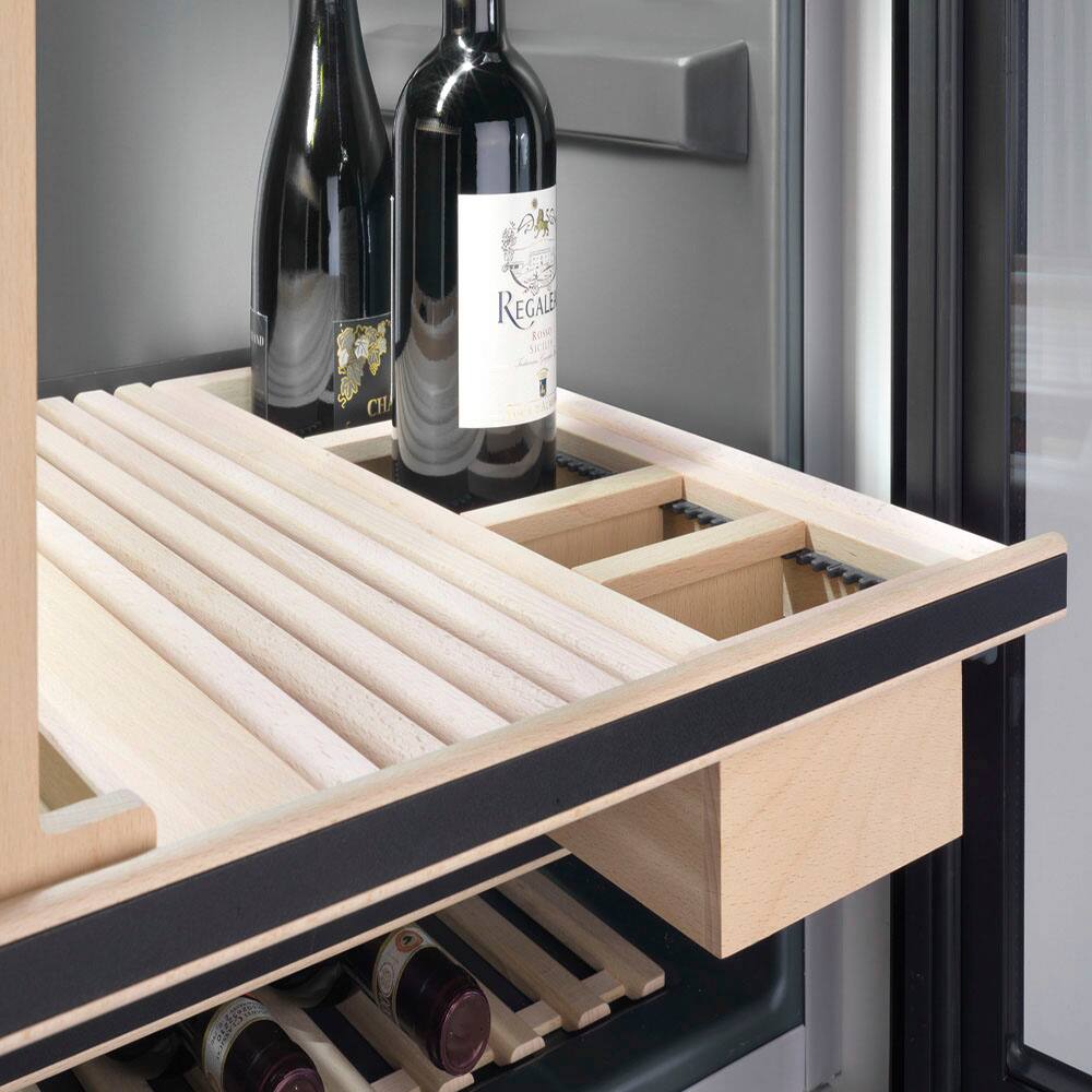 The image shows a wine rack with three wine bottles placed on it. The bottles are of different sizes and are arranged in a neat manner. The wine rack is located in a refrigerator, which is a common place to store wine bottles to keep them cool and well-preserved. The refrigerator itself is a large appliance that takes up a significant portion of the image.