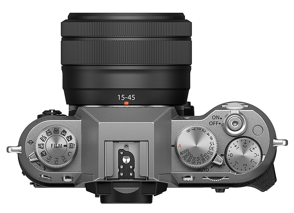 The image features a close-up of a digital camera with a lens on it. The camera has a silver body and a black lens. The camera is equipped with a viewfinder and a control panel with various buttons, including a power button, a shutter button, and a mode button. The camera also has a focus ring and a zoom ring, allowing for precise control over the focus and zoom settings. The overall appearance of the camera suggests that it is a professional-grade digital camera, designed for high-quality photography and videography.