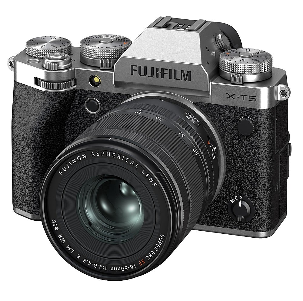 The image features a Fujifilm X-T5 digital camera with a large 50mm lens attached. The camera is in focus, and the lens is prominently displayed. The camera is positioned on a white background, which highlights its features and design.