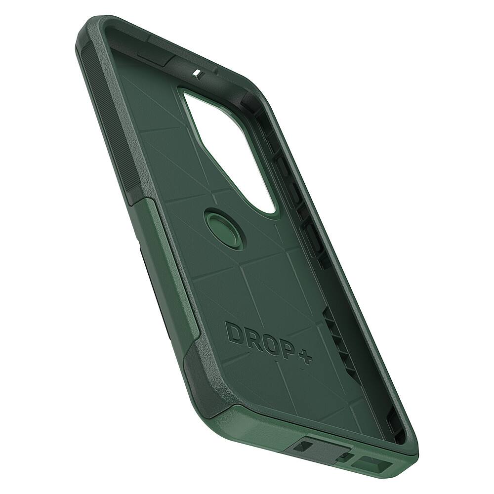 The image features a green case for a cell phone, which is designed by Drop. The case is made of hard plastic and has a geometric pattern on it. It is a close-up view of the case, showcasing its design and texture.