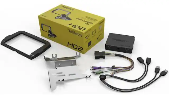 The image features a box of electronic components, including a Harley Davidson NOSZIAVO 201+ HD2 maestro HD2 Tastro. The box is yellow and contains various parts, such as a wiring harness, a control box, and a battery. The components are arranged on a white background, making the box and its contents stand out.
