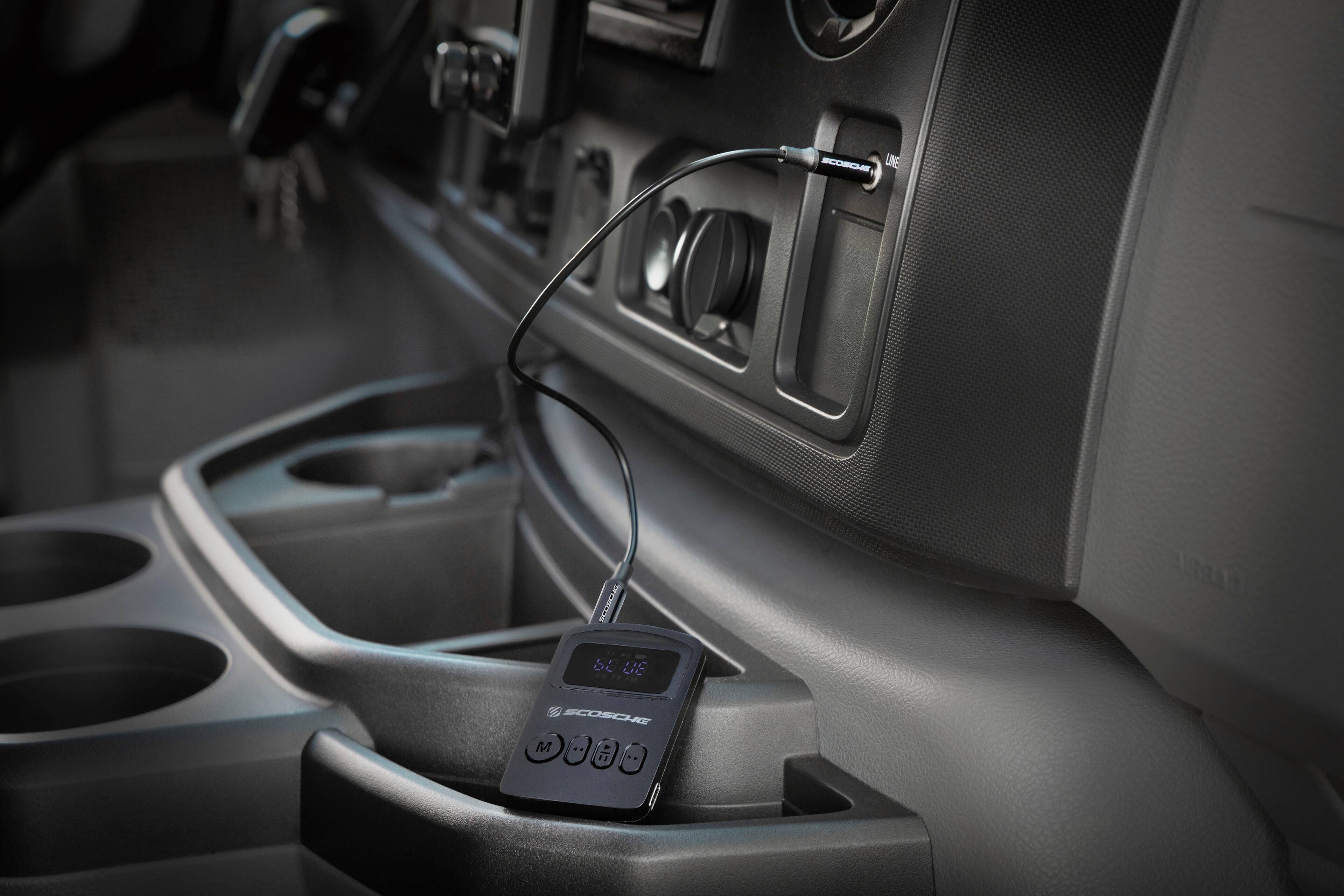 The image features a car with a small electronic device, possibly a radio or a GPS unit, sitting on the dashboard. The device is connected to the car's stereo system, and there is a wire running from the device to the car's speaker. The car appears to be a truck, and the dashboard is equipped with various controls and buttons. The scene showcases the integration of technology into modern vehicles, providing convenience and entertainment for the driver and passengers.