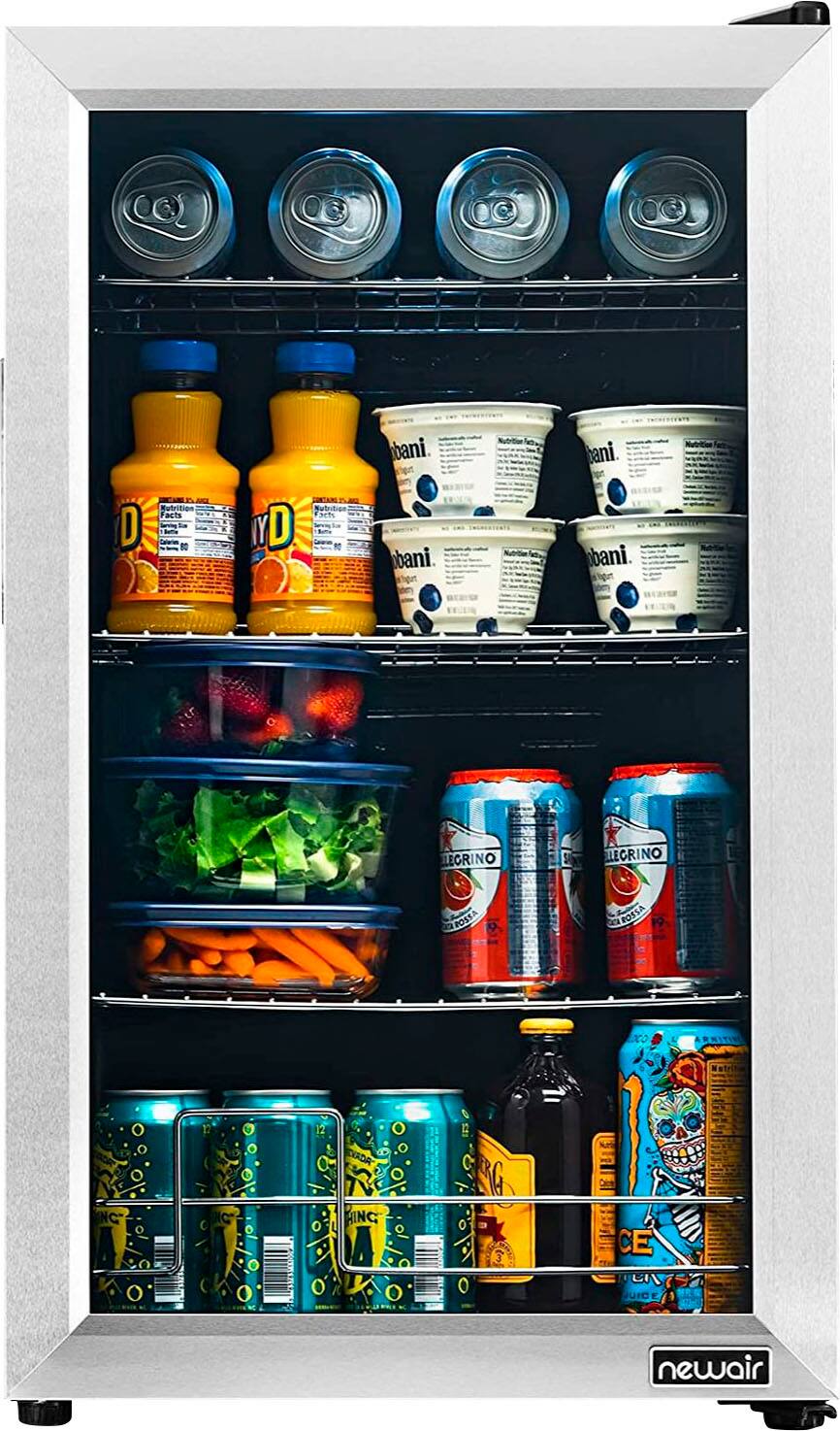 The image shows a refrigerator with its door open, revealing a variety of food and drinks inside. There are several bottles of juice, milk, and soda, as well as a bowl of yogurt. The refrigerator is well-stocked, with a variety of items to choose from.