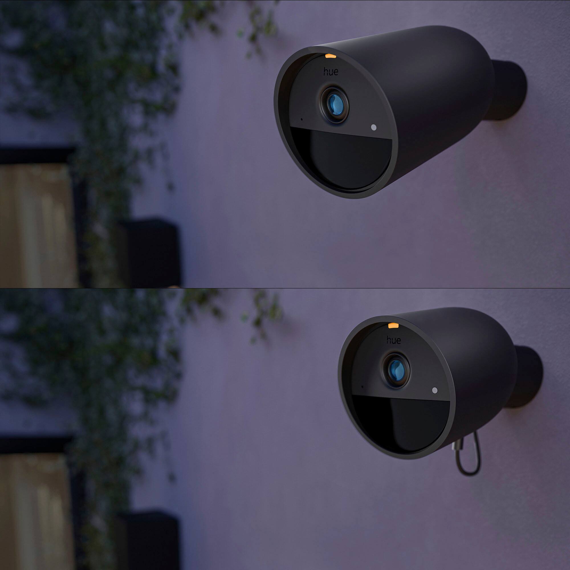 The text on the image is "hue hue," which is a reference to the Hue Bridge, a device used to control and automate smart lighting systems. The image shows a close-up of a Hue Bridge mounted on a wall.