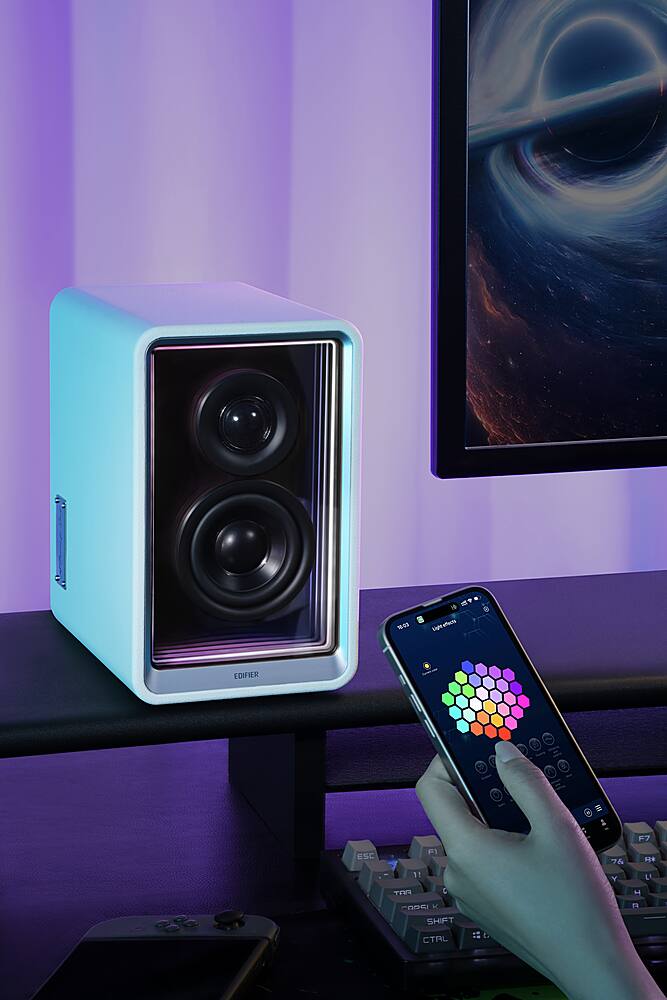 "Edifier" is a brand of speakers, and the image shows a person holding a smartphone next to a pair of Edifier speakers. The person is likely using the smartphone to control or interact with the speakers.