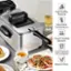 The image features a kitchen scene with a silver appliance, possibly a toaster oven or a microwave, sitting on a table. The appliance is accompanied by a cup of tea, a plate of food, and a glass of wine. The image also includes a dining table and a spoon. The text on the image reads: "High Quality Material Adjustable Temperature 1700W Heating Element 3.2qt Capacity Oil Container Easy to Clean."