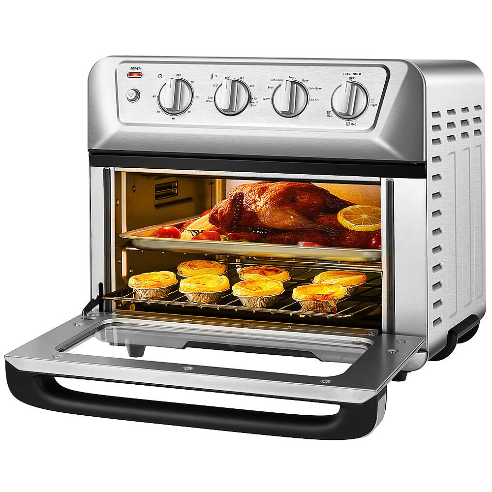 The image shows a stainless steel oven with a turkey and some pies inside. The oven has a digital display and a timer, indicating that it is a modern appliance. The turkey and pies are placed on a rack, which is located in the middle of the oven. The oven is open, revealing the delicious meal being cooked inside.