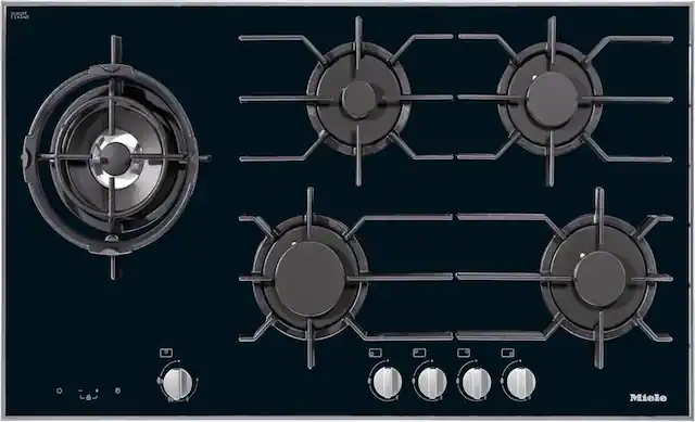 The image shows a stove with four burners and a clock. The stove is made by Miele, a well-known brand for high-quality appliances. The clock is located on the left side of the stove, and the burners are arranged in a diamond pattern, with one burner in the center and three others surrounding it. The stove is designed with a modern aesthetic and is likely to be a popular choice for home cooking enthusiasts.