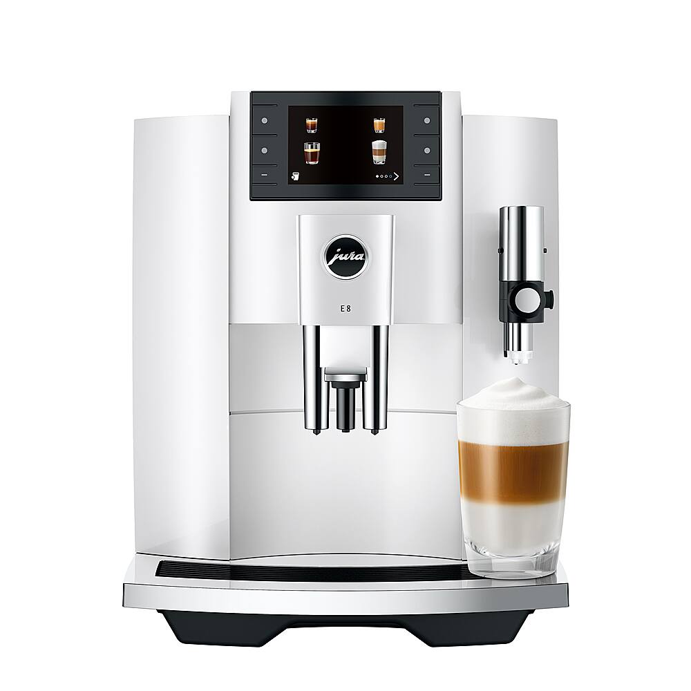 The image features a Jura coffee machine with a cup of coffee and a glass of milk. The coffee machine is white and has a black screen, and it is equipped with a frother. The coffee is being poured into the glass of milk, creating a delicious coffee drink. The machine is designed for easy use and is perfect for making a variety of coffee drinks.