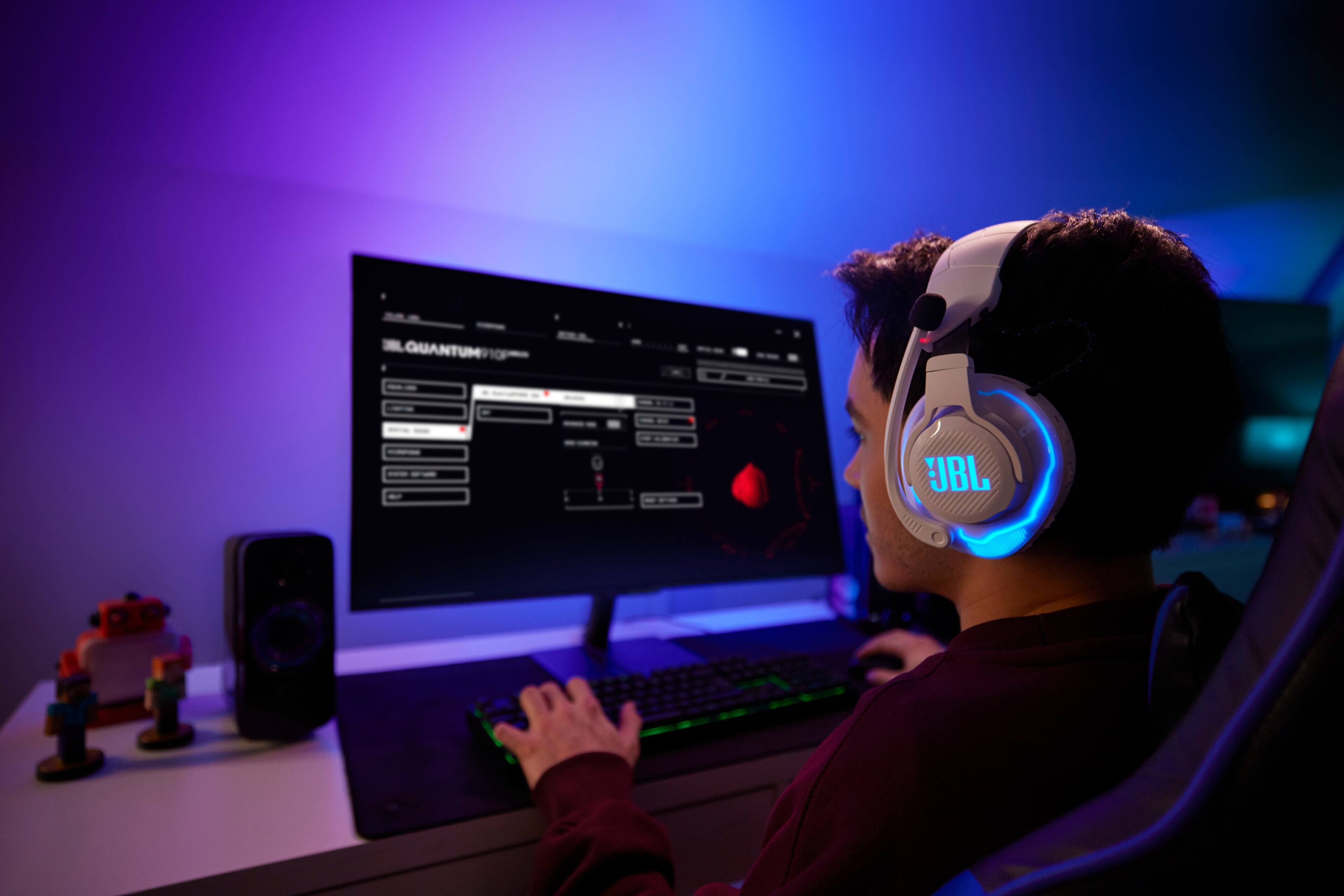 The largest text in the image reads "QuantumIO" on the computer screen. The cleaned-up text based on the image would be "Quantum IO."