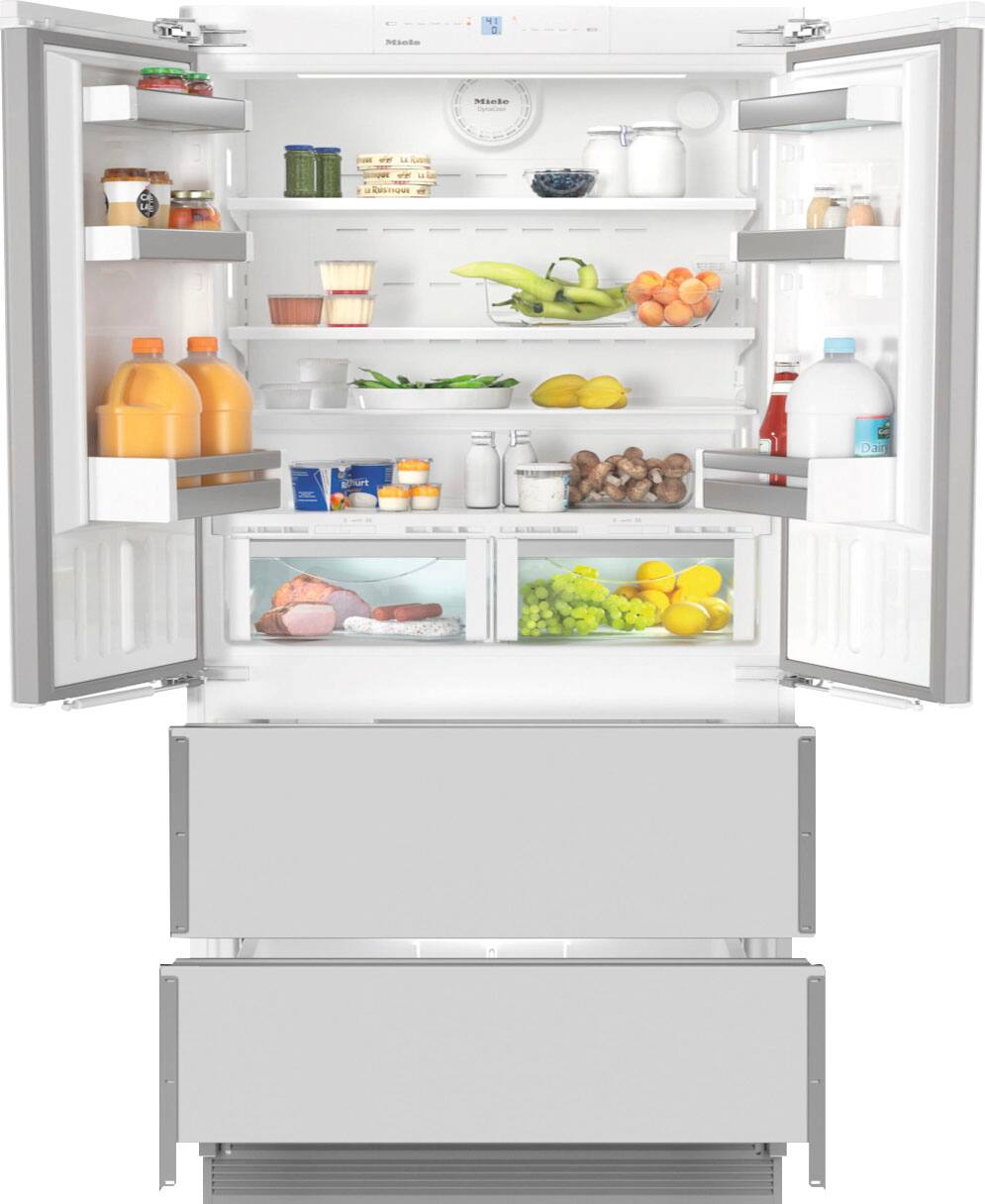 The image features a large refrigerator with its door open, revealing a well-stocked interior. The refrigerator is filled with various food items, including fruits, vegetables, and multiple bottles of juice. There are also several bowls placed throughout the refrigerator, likely containing different types of food. The refrigerator is organized in a way that makes it easy to find and access the items stored inside.