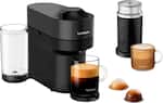 The image features a Nespresso coffee maker with a cup of coffee and a glass of milk. There are also two cups of coffee and a glass of milk on the table. The coffee maker is black and silver, and it is accompanied by a coffee maker and a glass of milk.