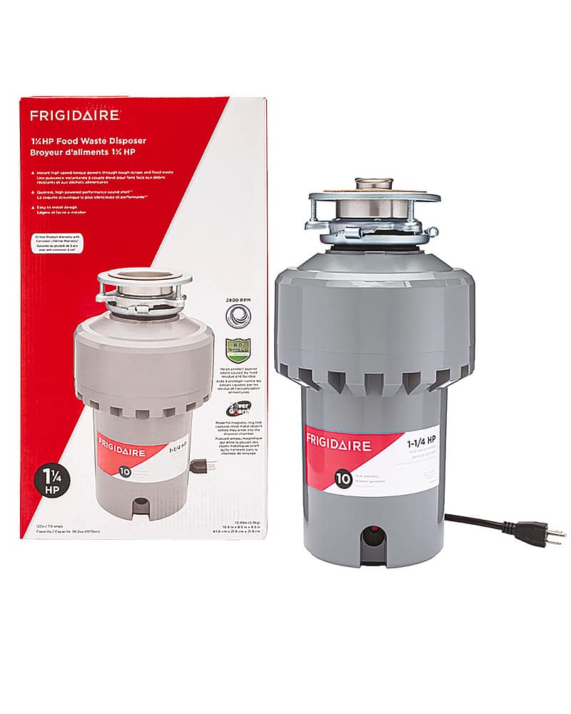 The image features a Frigidaire 1 1/4 HP food waste disposer with a silver lid. The appliance is placed next to its box, which is still unopened. The box is red and white, and it contains the necessary instructions and information for the proper installation and use of the food waste disposer. The appliance is designed to help reduce food waste and maintain a clean and hygienic kitchen environment.