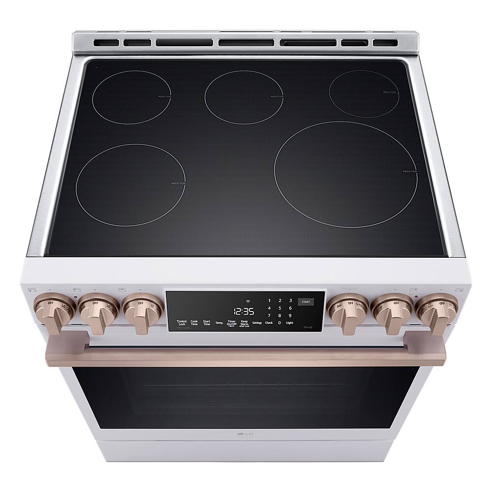 The image shows a stove with a digital display showing the time of 12:35. The stove has four burners and a timer, making it a versatile and functional appliance for cooking.