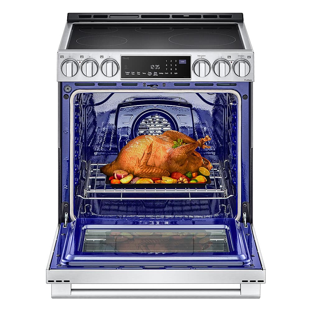 The image shows a large, blue oven with a turkey inside. The oven has a digital display, and the turkey is placed on a rack. The oven is open, revealing the cooked turkey.