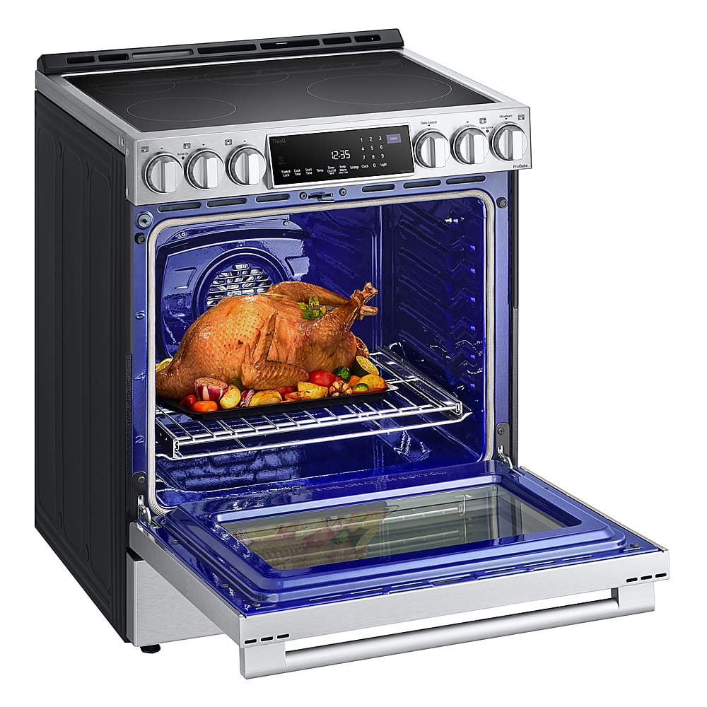The image shows a blue oven with a roasted turkey inside. The oven is open, revealing the cooked bird. The oven is equipped with a digital display, which shows the time and temperature of the cooking process. The turkey is placed on a rack inside the oven, ensuring even cooking and easy access for serving. The oven appears to be a modern and efficient appliance, perfect for preparing delicious meals like this roasted turkey.