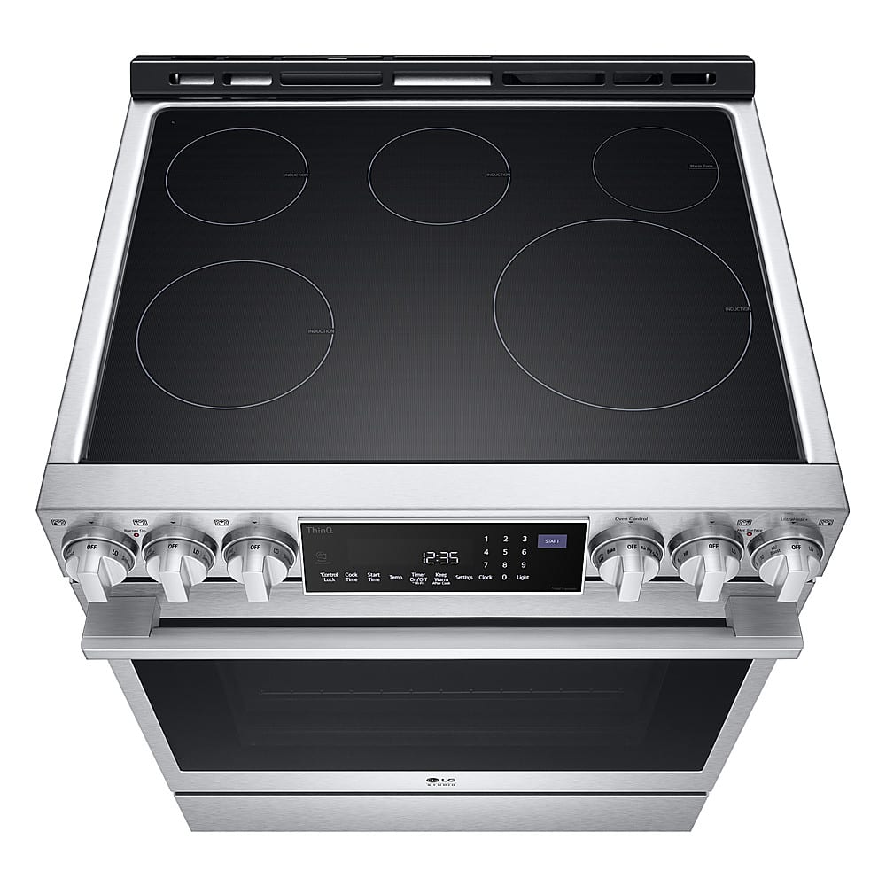 The image shows a stainless steel stove with a black glass top. The stove has a digital display that reads "12:35." The display also shows the time and the temperature settings for the oven. The stove has a total of six burners, with four on the top and two on the bottom. The oven is also equipped with a timer and a clock, which can be used to monitor cooking times and ensure that food is cooked to perfection.