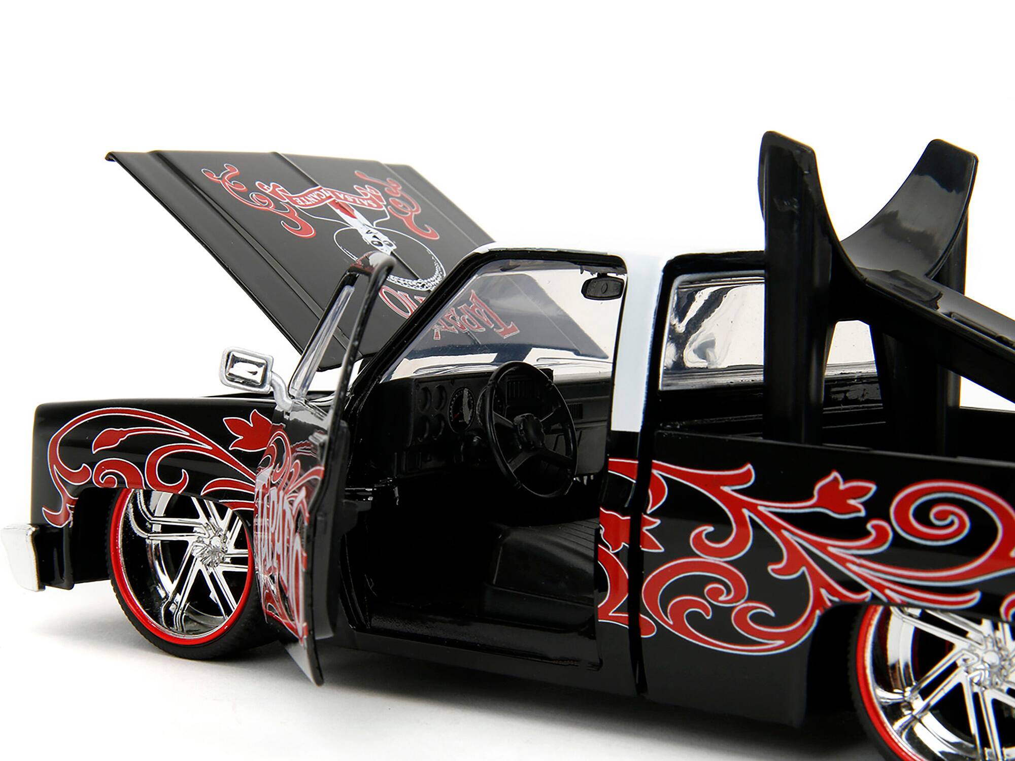 Left. Jada - 1985 Chevrolet C-10 Pickup Truck Black with White Top and Graphics with Charro Man Diecast Figure "Tapatio" 1/24 - Black, White.