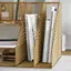 I'm sorry, but the text you provided does not make sense and does not provide any context for grouping or correction. The image shows a wooden bookshelf with books and magazines on it, and I cannot provide a meaningful response based on the given text.
