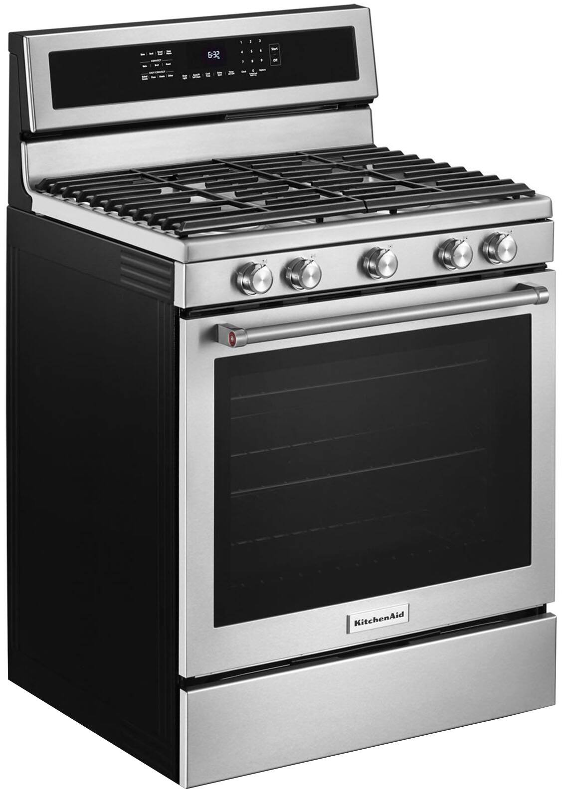 The image features a stainless steel oven with a black door, sitting on top of a stove. The oven has a digital display and a timer, indicating that it is a modern and advanced appliance. The stove is built into the wall, providing a sleek and integrated look in the kitchen. The oven is likely a part of a larger kitchen setup, offering convenience and efficiency for cooking and baking tasks.