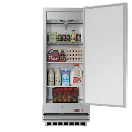 The refrigerator is stocked with various food items, including milk, eggs, and apples. There are also several bottles of drinks, such as juice and soda, as well as a carton of eggs. The refrigerator is open, revealing the assortment of items inside.