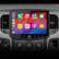 The image shows a car's dashboard with a built-in display screen. The screen displays various apps, including a phone, music, maps, messages, and podcasts. The car also has a radio and audiobooks available as options. The car's dashboard also has buttons for controlling the air conditioning and other functions. The time displayed on the screen is 2:10.