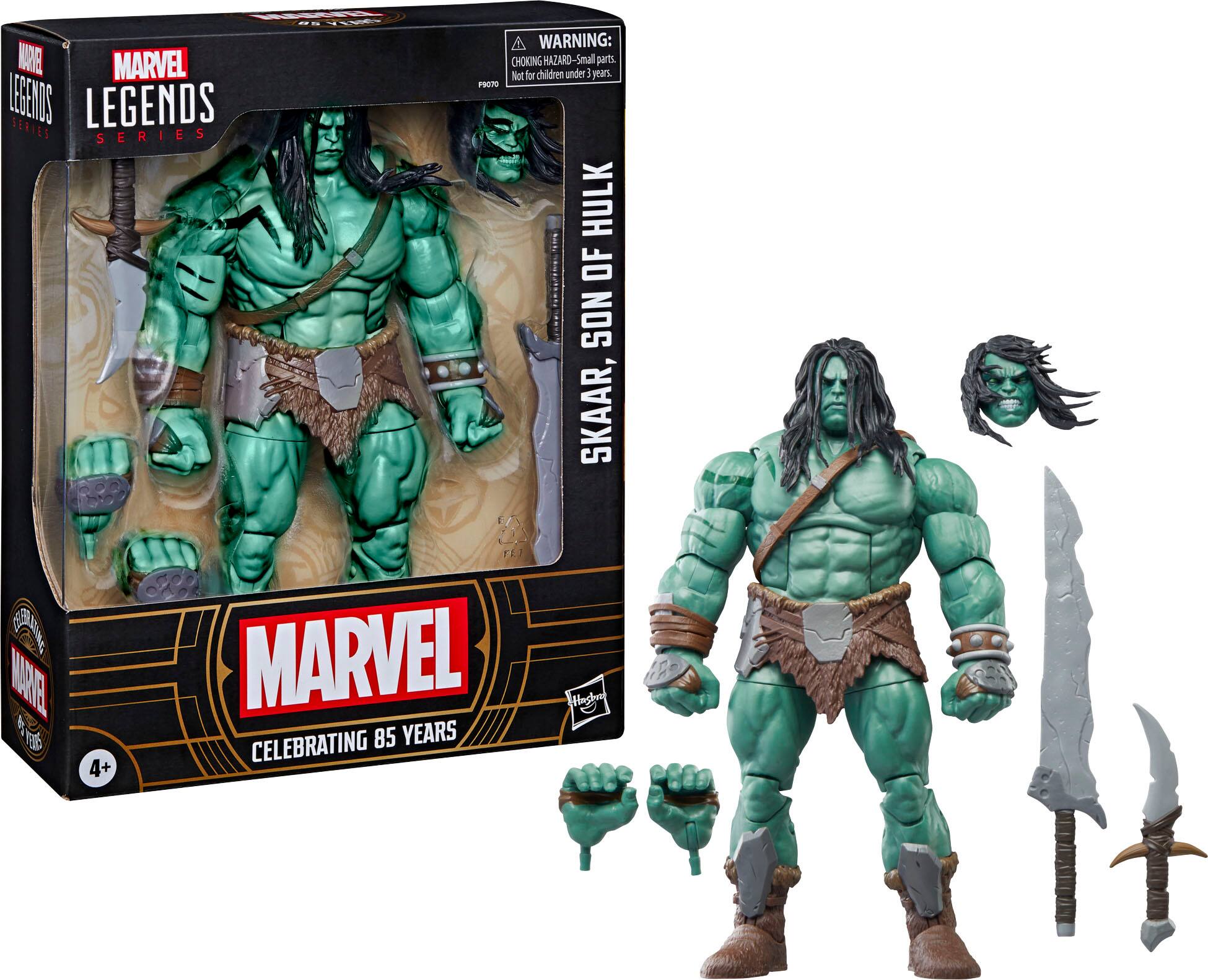The image features a green action figure of the Marvel character Hulk, which is part of the Legends Series. The figure is holding a sword and a shield, and it is posed in a dynamic stance. The packaging for the figure is also shown, indicating that it is intended for children and comes with a warning to avoid choking hazards. The figure is celebrating 85 years of Marvel Comics.