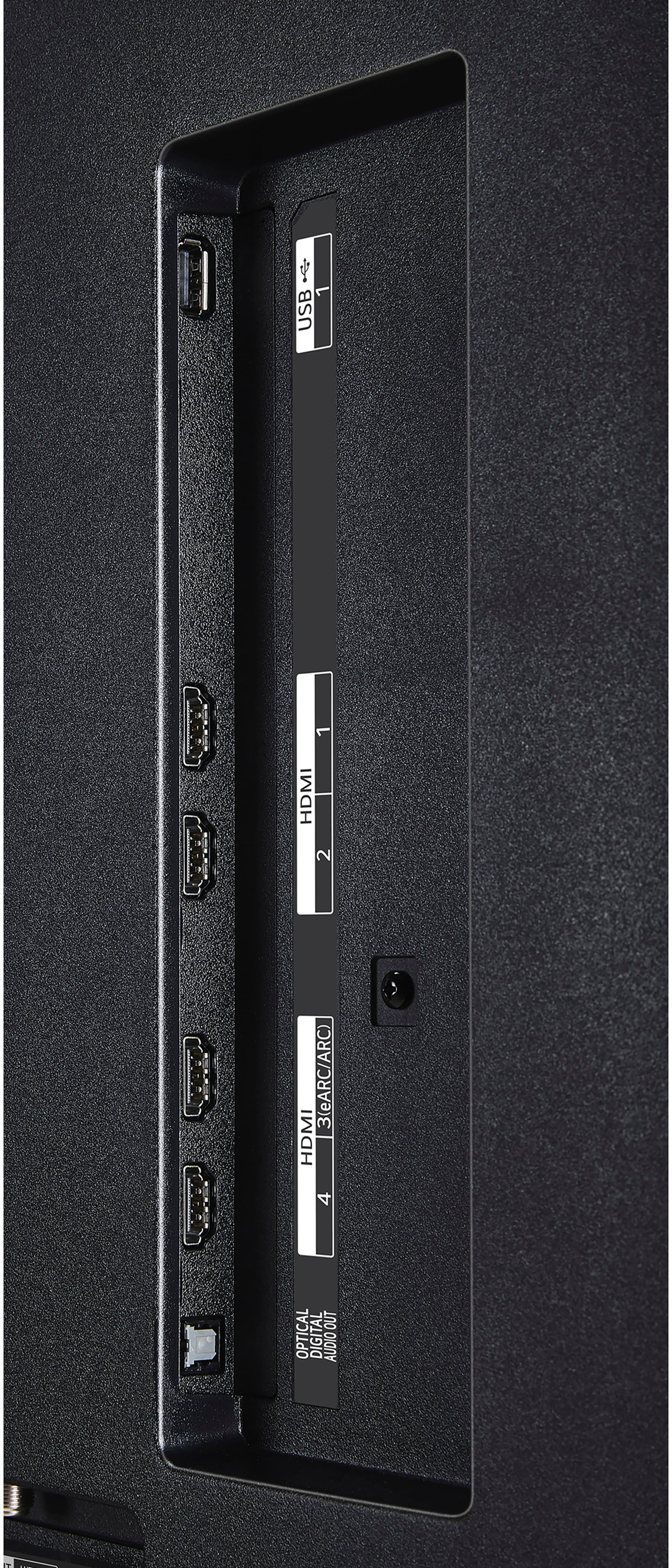 The image shows a black electronic device with a row of ports, including a USB port, an HDMI port, and an optical digital audio out port. The device also has a 2.1 channel audio system, which includes two speakers and a subwoofer. The back of the device features a number of ports, including a USB port, an HDMI port, and an optical digital audio out port. The device is designed to provide a high-quality audio and video experience for users.
