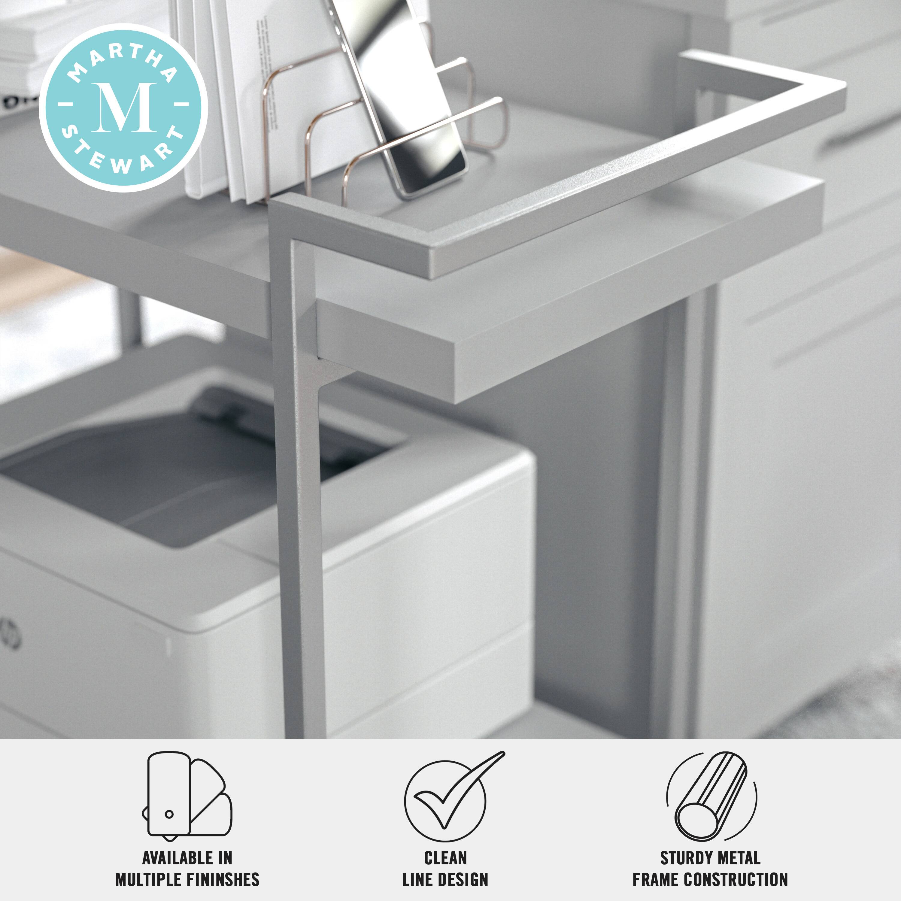 "Martha Stewart" is the brand name associated with the desk and shelving unit in the image. The desk is available in multiple finishes and features a clean line design. The shelving unit is made of sturdy metal construction.