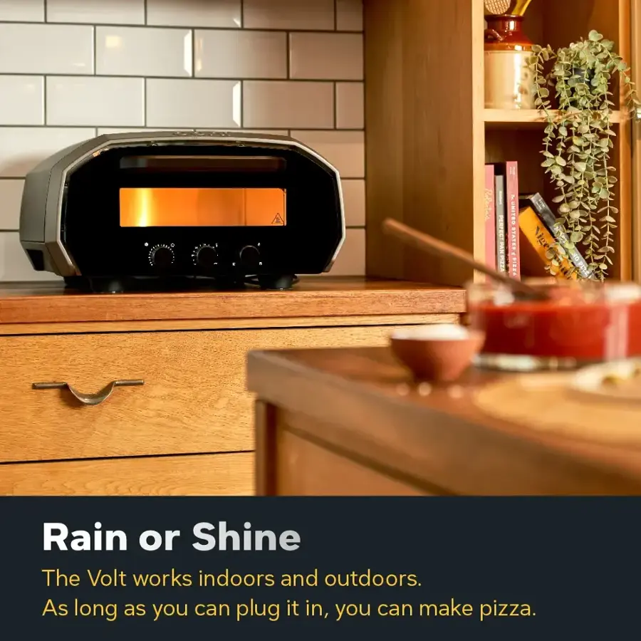 The text on the image is promoting a pizza oven that works both indoors and outdoors, and it can be used to make pizza. The text is titled "Rain or Shine" and emphasizes the convenience and versatility of the pizza oven.