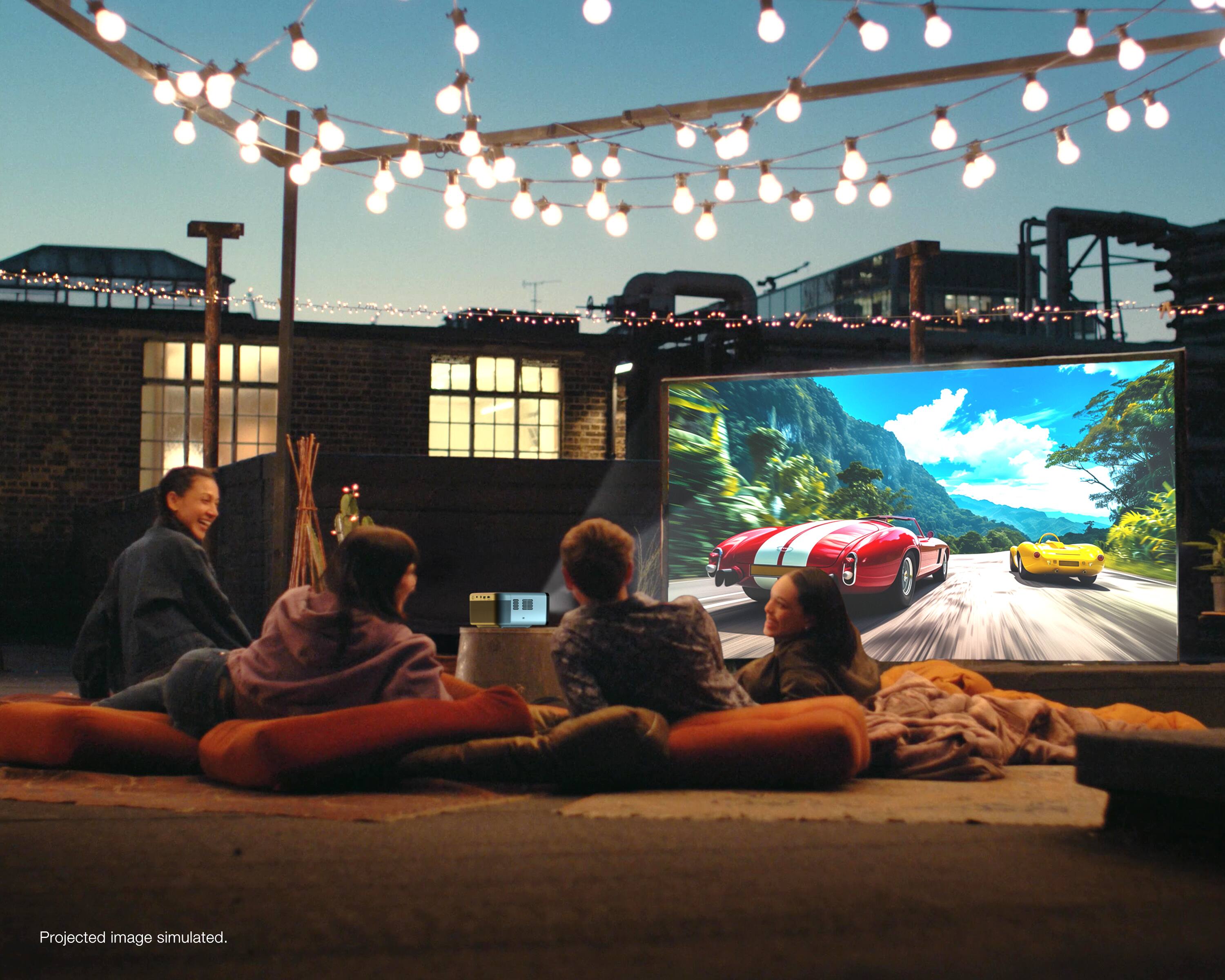 The image is a simulated projection of a group of people sitting on cushions and watching a large screen.