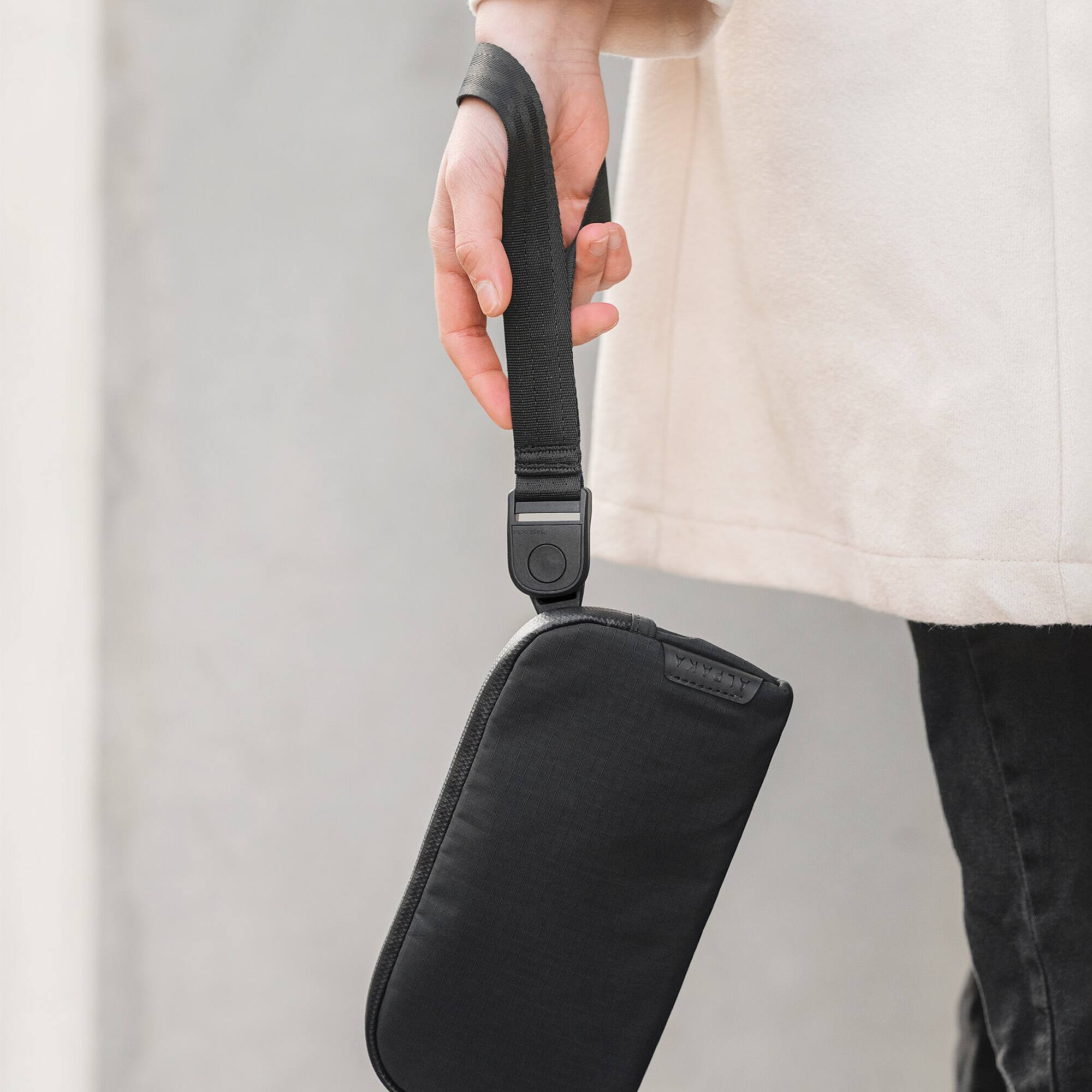 Angle. ALPAKA - Flight Pouch Crossbody Phone Bag & Travel Organizer for Passport, Phone, Cards & Everyday Carry, Weather-Resistant - Black Axoflux 210D.
