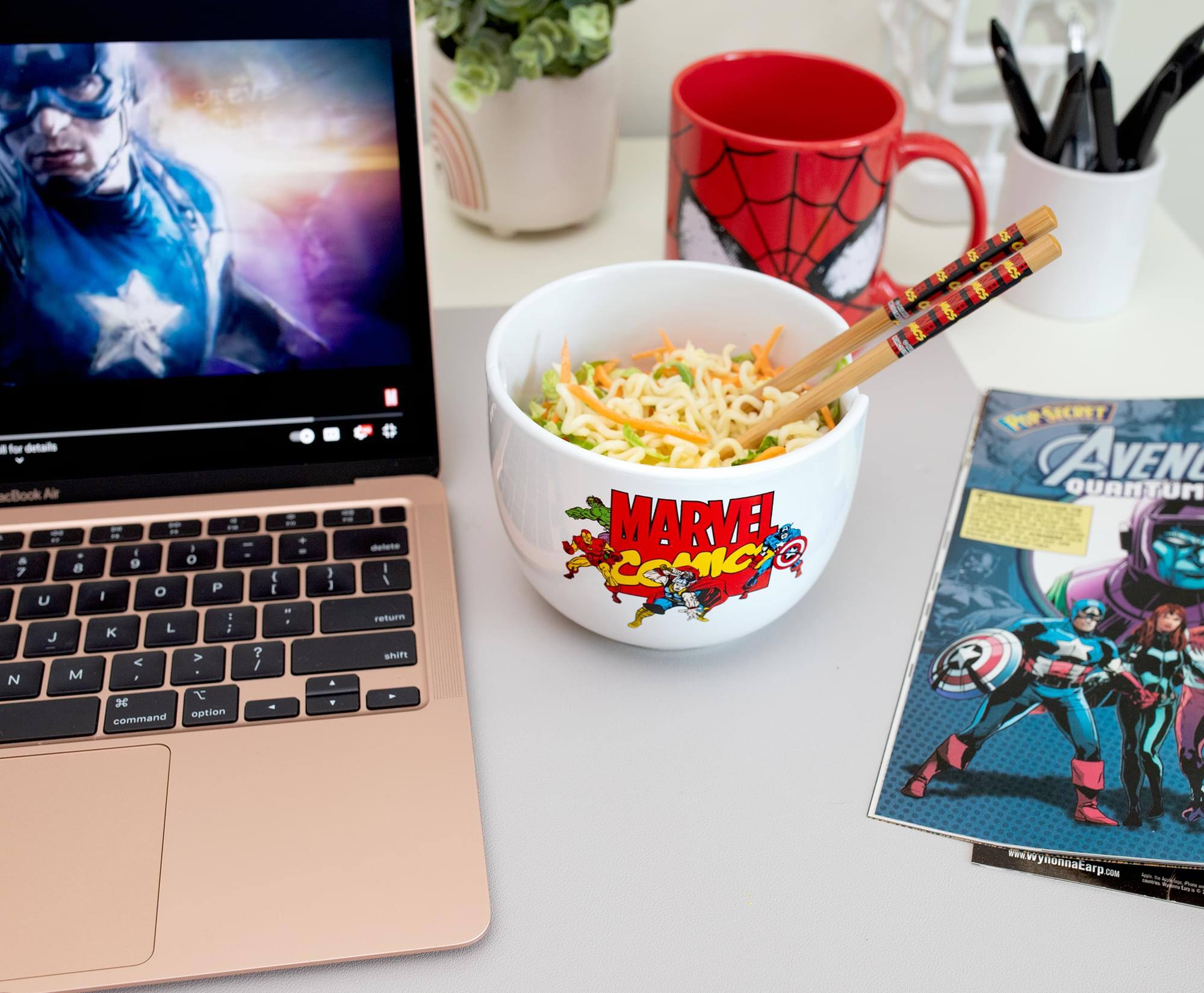 Sure, here is the corrected and grouped text from the image:

**From the laptop screen:**
- "for details"
- "acBook Air"

**From the comic book:**
- "The Secret"
- "AVENGERS QUANTUM"

**From the website:**
- "www.wyonnaearp.com"

**From the mug:**
- "MARVEL COMICS"

**From the keyboard:**
- "command"
- "option"
- "return"
- "shift"

**From the text on the image:**
- "MARVEL COMICS"
- "RPSICHT"
- "JAVEN"
- "QUANTUM"