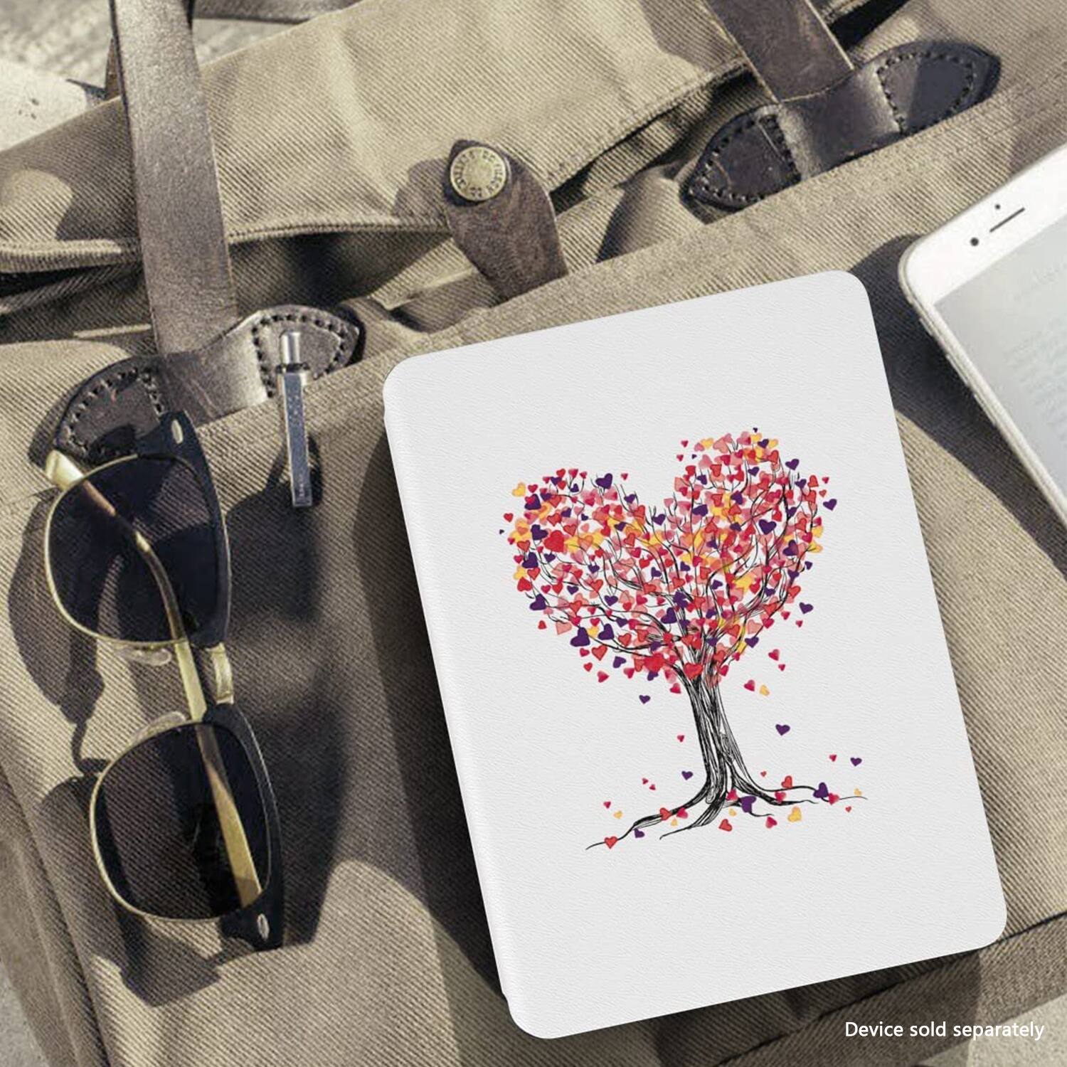 The image shows a heart-shaped notebook, a cell phone, and a pair of sunglasses. The heart-shaped notebook is placed next to the cell phone and the sunglasses. The text on the image reads "Device sold separately."
