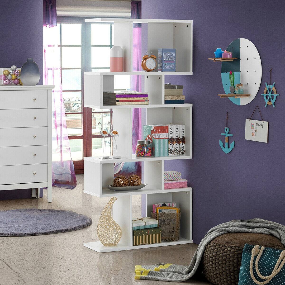 The image shows a bedroom with a white dresser and a bookshelf. The bookshelf is filled with various items, including books, a clock, and a vase. The dresser is also decorated with a mirror and a few other items. The room has a purple wall, and there is a window nearby. The overall scene is organized and well-decorated, creating a cozy and inviting atmosphere.