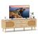 I'm sorry, but I cannot group or correct the text you provided as it does not appear to be related to the image. The image features a flat screen TV sitting on top of a wooden stand, with a potted plant nearby.