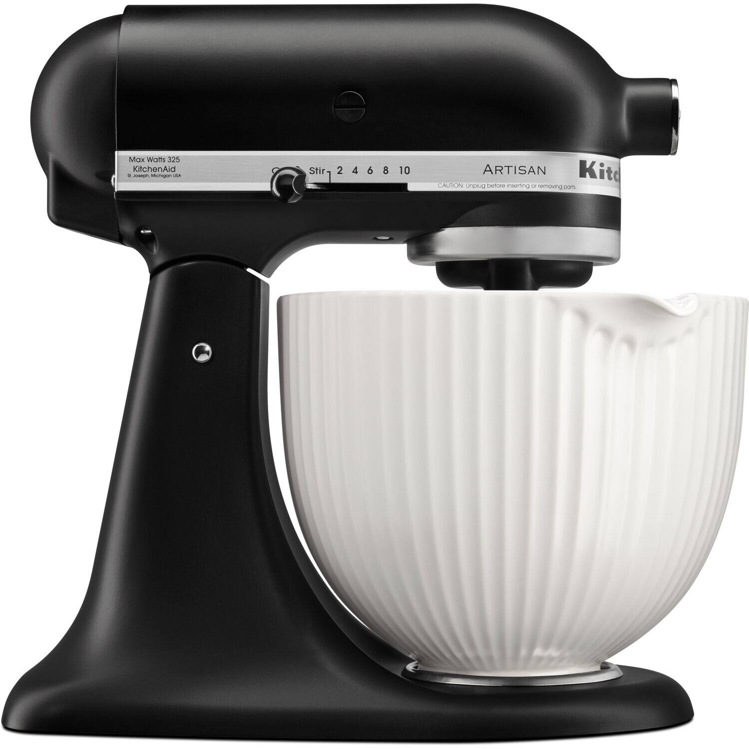 The image features a black and white KitchenAid mixer with a white bowl on top of it. The mixer is being used to mix the contents of the bowl. The mixer is made by the Artisan brand and has a capacity of 4.5 to 6.5 liters. The bowl is placed on top of the mixer, and the mixer is in the process of mixing the contents.